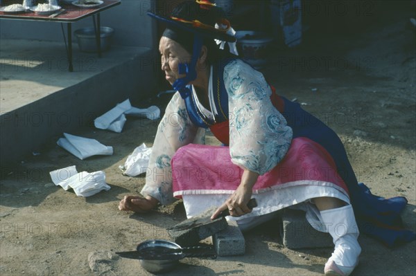 SOUTH KOREA, General, Shamanism.  Female mudang whose role is to act as an intermediary between the living and spirit worlds attending funeral.