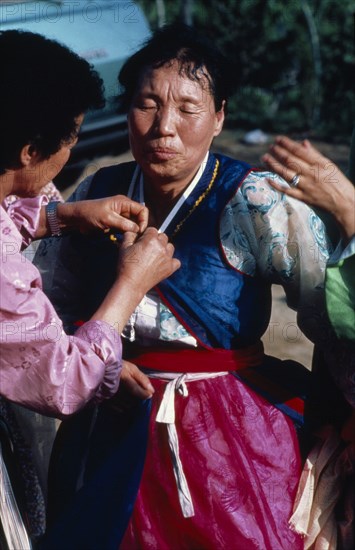 SOUTH KOREA, Religion, Shamanism, Female mudang whose role is to act as an intermediary between the living and spirit worlds in trance at a funeral.