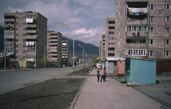ARMENIA, Vanadzor, Children on street beside residential flats.
