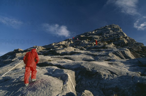 MALAYSIA, Borneo, Sabah, Tourists approaching Lows Peak the summit of Mount Kinabalu.