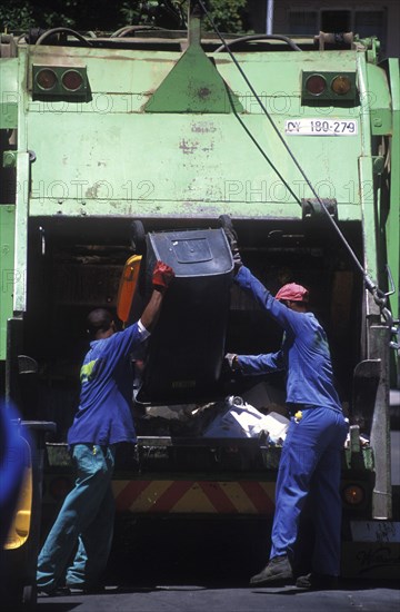 SOUTH AFRICA, Western Cape, Paarl, Municipal refuse collectors emptying waste bins into the truck