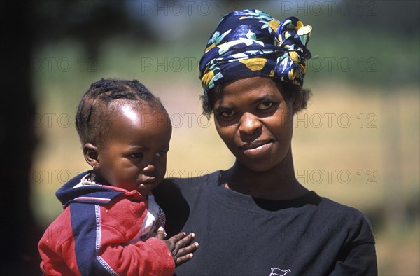SOUTH AFRICA, Western Cape, Paarl, Farm labourers wife and child at Fairview goats cheese and wine estate