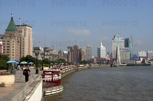 CHINA, Shanghai, The Bund aka Zhong Shan Road. View along the promenade that runs along the Huangpu River with the city skyline in the distance