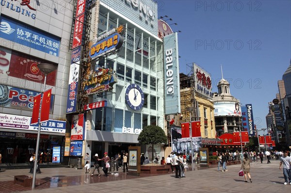 CHINA, Shanghai, Nanjing Road walking street. Commercial shopping street with building facades covered with advertising signs