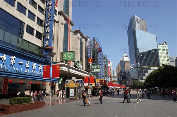 CHINA, Shanghai, Nanjing Road walking street. Commercial shopping street with building facades covered with a mass of advertising signs