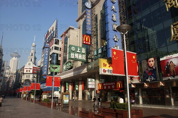 CHINA, Shanghai, Nanjing Road walking street. Commercial shopping street with building facades covered with a mass of advertising signs