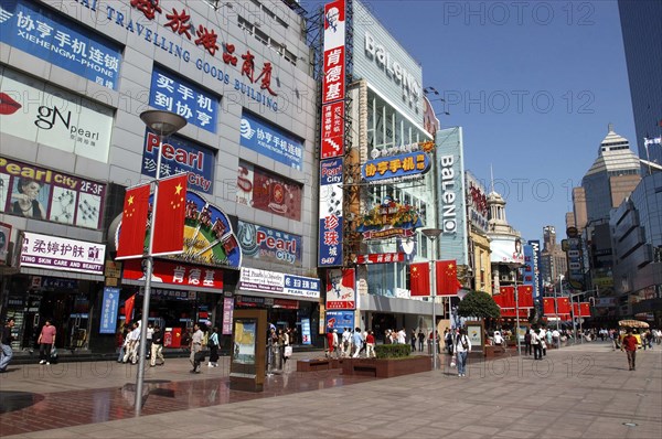 CHINA, Shanghai, Nanjing Road walking street. Commercial shopping street with building facades covered with a mass of advertising signs