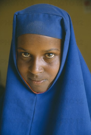 ETHIOPIA, Jijiga, Portrait of Somali girl in blue head dress.  The Somali are one of the key ethnic groups in Ethiopia and are largely Muslim pastoralists.