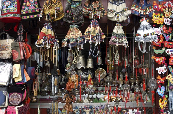 CHINA, Beijing, Market stall displaying selection of bells bags and chimes with assortment of ornaments