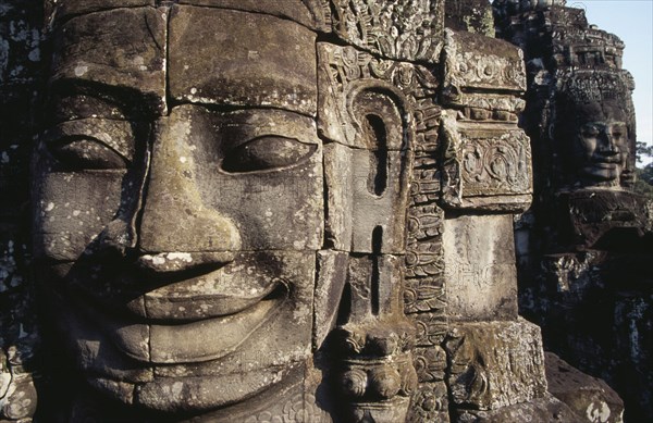 CAMBODIA, Siem Reap, Angkor Thom, Bayon Temple detail of two of the four faced towers