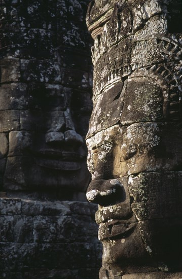 CAMBODIA, Siem Reap, Angkor Thom, Bayon Temple details of two of the four faced towers