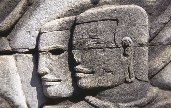 CAMBODIA, Siem Reap, Angkor Thom, Bayon Temple south gallery bas relief of two male faces