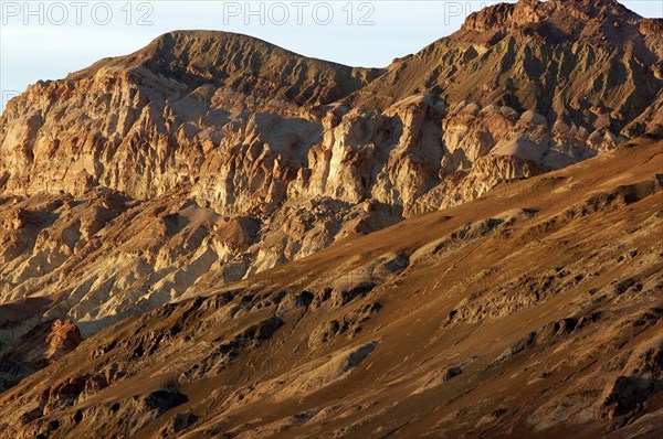 USA, California, Death Valley, View of red layered sculpted rock hills
