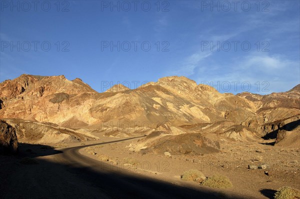 USA, California, Death Valley, View over layered sculpted rock hills in the golden afternoon sun