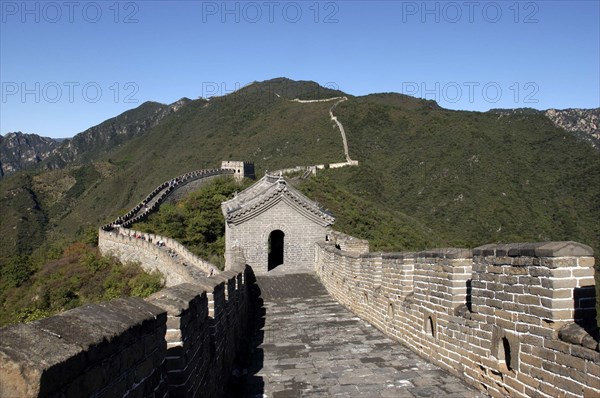 CHINA, Great Wall, View along a section of the wall which runs through the green hilly landscape