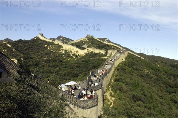 CHINA, Great Wall, View alongside a section of the wall which runs through the hilly green landscape covered in tourists