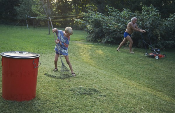 ENGLAND, Gardens, Father and eight year old boy gardening.