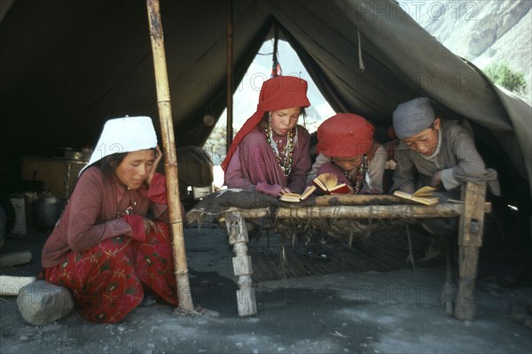 AFGHANISTAN, Tribal People, Kirghiz children taking lessons inside yurt.