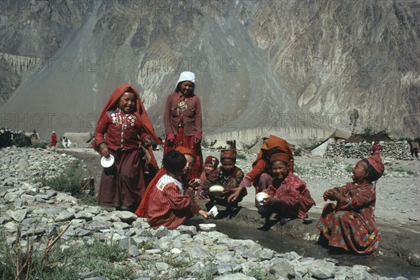 AFGHANISTAN, Tribal People, Group of Kirghiz children washing bowls in stream.