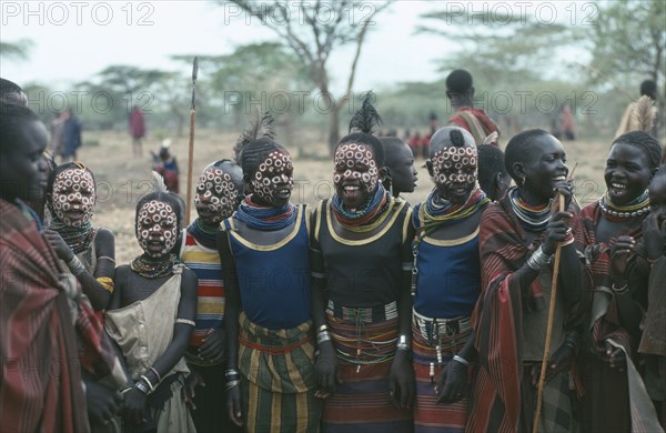 UGANDA, Karamoja  , Young Karamojong girls with giraffe markings painted on their faces in preparation for dance during Akiudakin cattle bleeding ceremony.