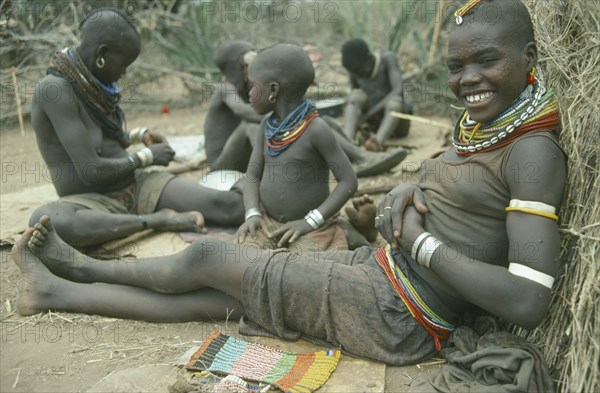 UGANDA, Karamoja, Karamojong girl from the Mathenico clan wearing traditional bead jewellery and with beadwork to be worn by unmarried girls.