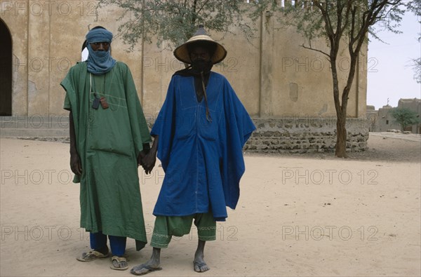 MALI, People, Two Touareg men in traditional dress holding hands.