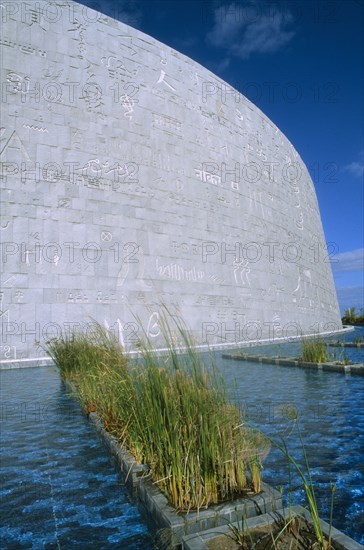 EGYPT, Nile Delta, Alexandria, Exterior view of the Library which has been resurrected on the site of the Bibliotheca Alexandrina with scripts of the worlds major civilizations engraved on the walls