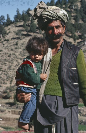 AFGHANISTAN, Paktia Province, Portrait of Jaji tribesman and son.  The Jaji are one of the Pathan tribes who also inhabit Western Pakistan and formed the power base of the Taliban.