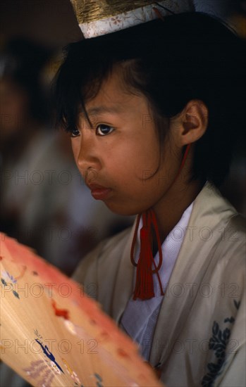 JAPAN, Kyushu, Kaseda, Portrait of young girl dressed as shrine maiden during Samurai Festival.