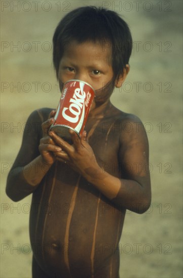 BRAZIL, Para, Amazon, Kayapo child with can of Coca Cola.
