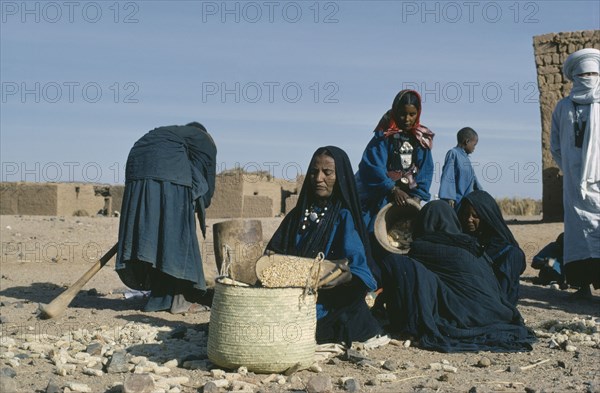 NIGER, Tribal People, Group of Tuareg women with basket of grain.