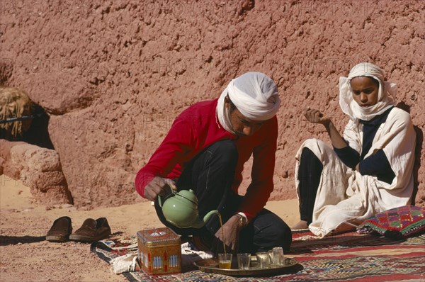ALGERIA, Tribal People, Tuareg man pouring tea.