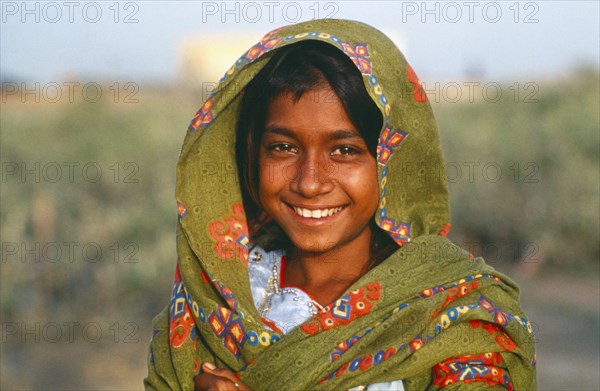 PAKISTAN, Sindh Province, Portrait of smiling Gypsy girl.
