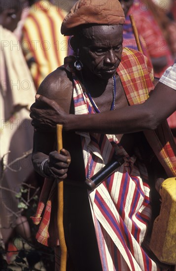 KENYA, Kajiado, Many of the Maasai men get so drunk on Gourds filled with honey beer that they can barely stand and are drunk at the beginning of an initiation ceremony that will bring the young Maasai Moran or young warriors into manhood.
