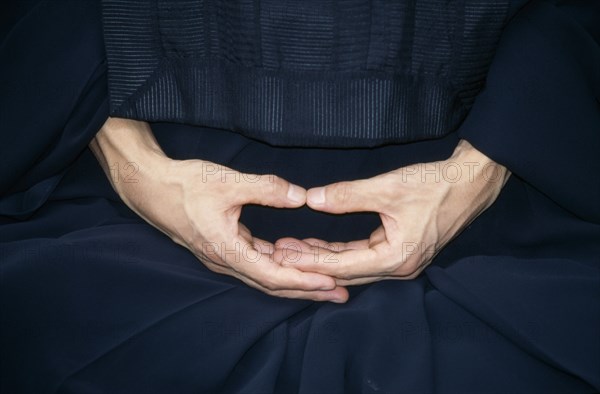 JAPAN, Zen, Cropped view of monk in Zen Buddhist monastery showing hands in Mudra the position of meditation