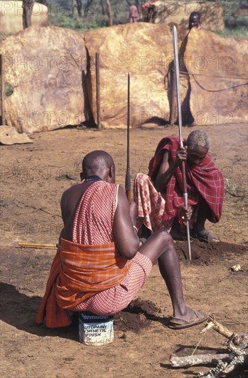 KENYA, Kajiado, Maasai elders prepare the ground for a meat feast  which is part of the initiation ceremony that will bring the Maasai Moran into manhood.