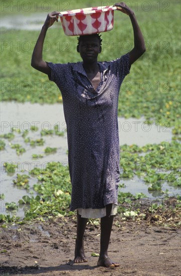 KENYA, , A woman collecting water from a lake source. Contaminated water sources are the leading cause of stomach illness in Africa.