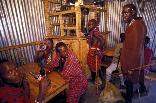 KENYA, Near Kajiado, Maasai Moran drinking in a bar. Alcoholism is a particular problem amongst the Maasai.