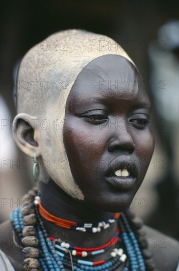SUDAN, Body Decoration, Portrait of young Dinka woman with facial decoration of ash paint and scarification.
