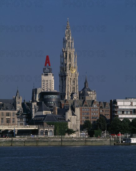 BELGIUM, Flemish Region, Antwerp, Cathedral of Notre Dame from across the River Scheldt with the Torengebouw and Steen Castle.