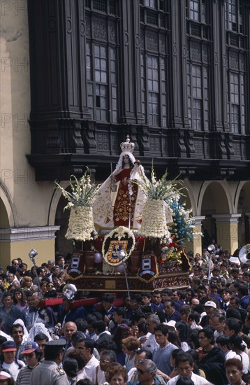 PERU, Lima, Traditional May 1st Festival with effigy of Virgen de Chapi being carried above the crowds