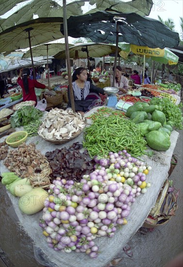 LAOS, Louangphrabang, Wide angled view of female vendor selling fresh fruit and vegetable produce at the market