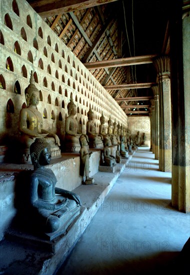 LAOS, Vientiane, View along row of seated Buddha statues at Wat Si Saket