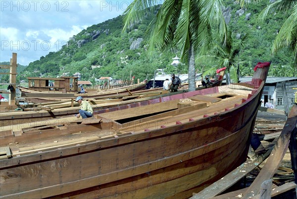 VIETNAM, South, Nha Trang, Building a new fishing fleet with half built wooden ships in the foreground