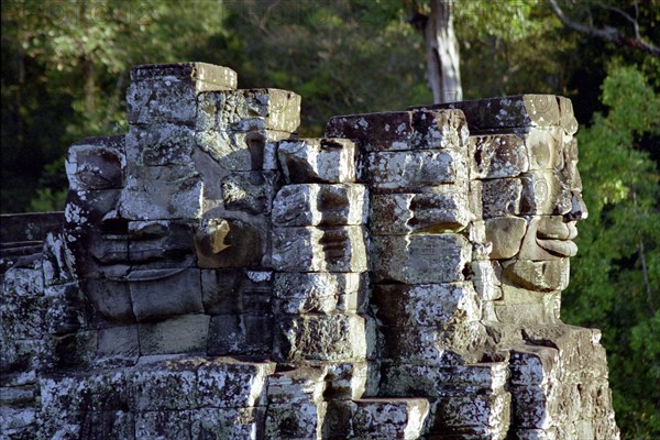 CAMBODIA, Angkor, The Bayon. Two of the faces of the late twelth to early thirteenth century pyramid temple built in the centre of the ancient city of Angkor Thom