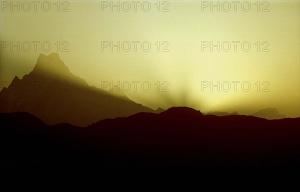 NEPAL, Annapurna Massif, Mountain range in silhouette at sunset viewed from Poon Hill