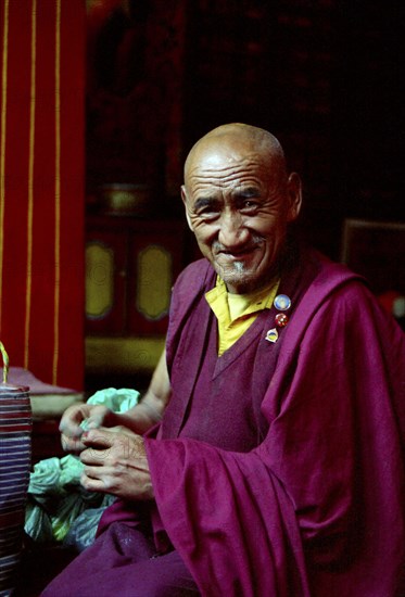 INDIA, Sikkim, Rumtek Gompa, Portrait of monk performing Pujar ceremony  and the making of a spiritual Mandala