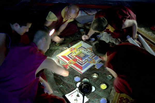 INDIA, Sikkim, Rumtek Gompa, Several monks painting decorative patterns for the Pujar ceremony  and the making of a spiritual Mandala