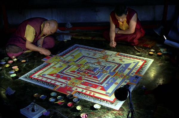 INDIA, Sikkim, Rumtek Gompa, Two monks painting decorative patterns for the Pujar ceremony  and the making of a spiritual Mandala