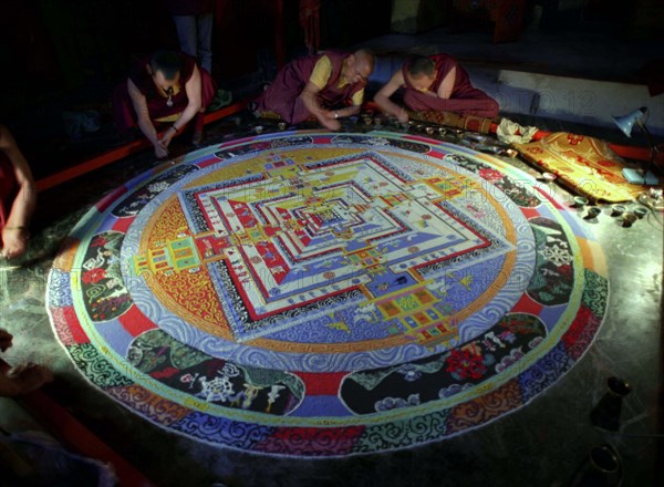 INDIA, Sikkim, Rumtek Gompa, Several monks painting decorative patterns for the Pujar ceremony  and the making of a spiritual Mandala